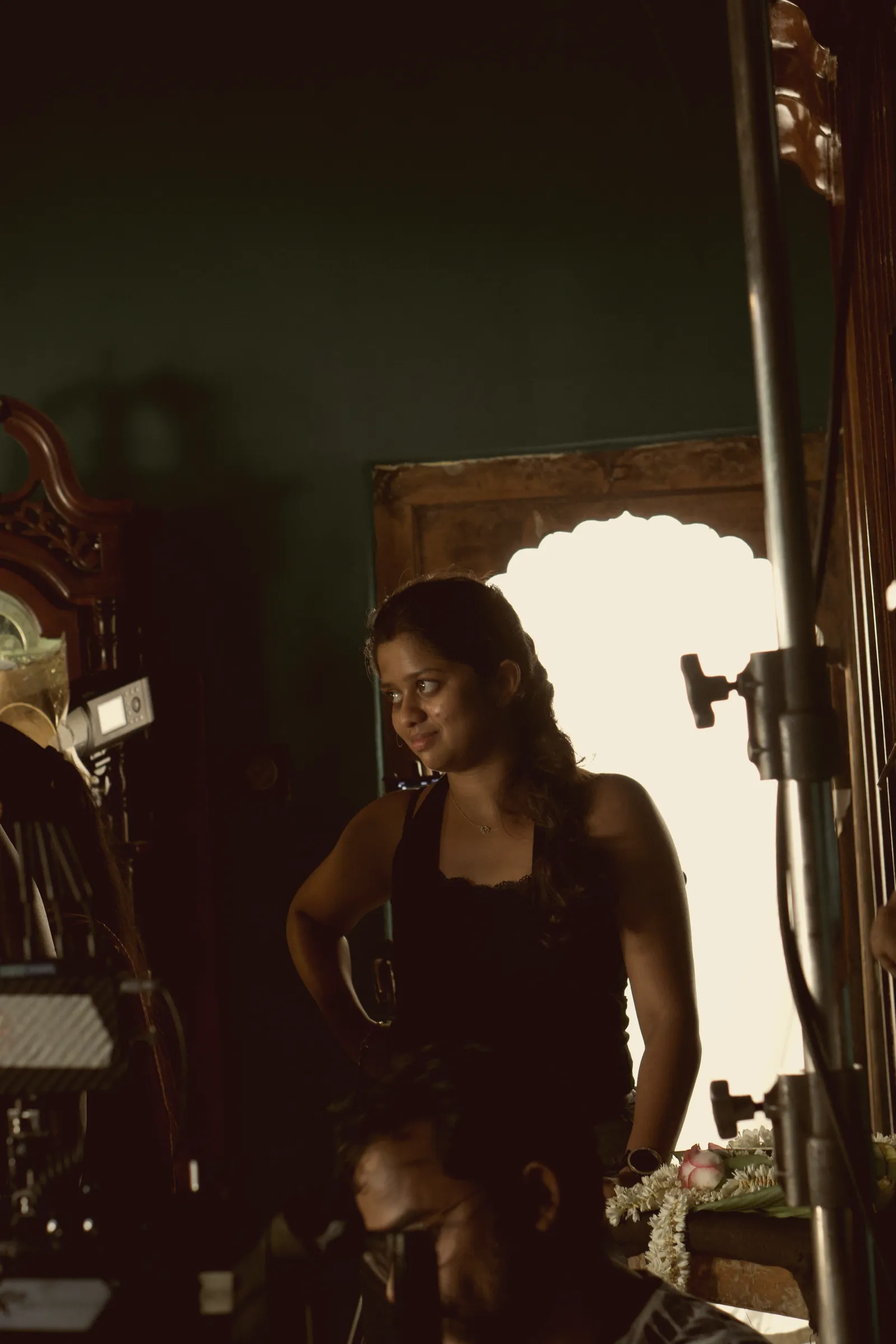 Ananya on set beside a light stand